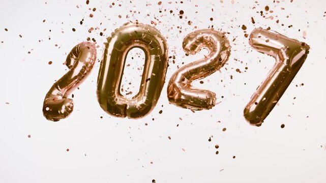 Rose Gold 2027 Balloons with Golden Confetti Falling on White Background
