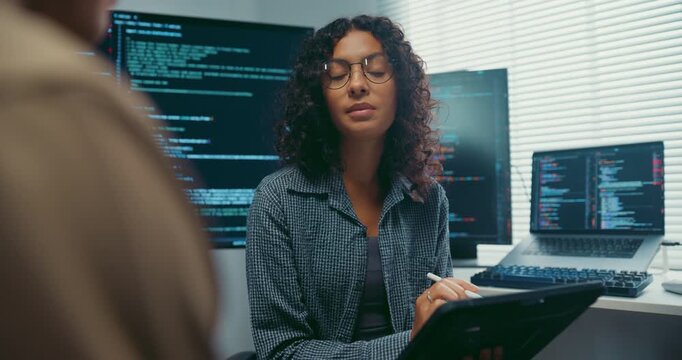 Diverse team developer uses tablet discuss AI coding and project strategy at office. Artificial intelligence software debugging, Cybersecurity database server, Machine learning app meeting concept.