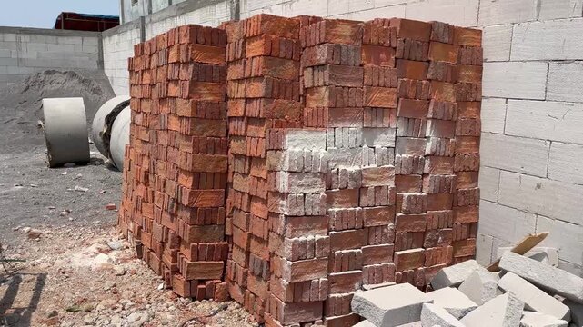 Neatly Stacked Red Clay Bricks on Industrial Construction Site