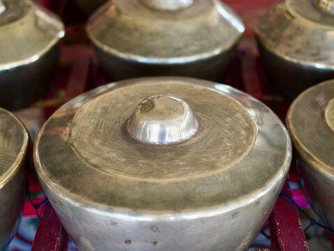 A detailed cultural image of a traditional Indonesian bonang instrument, featuring the distinctive layout of a Javanese gamelan ensemble.