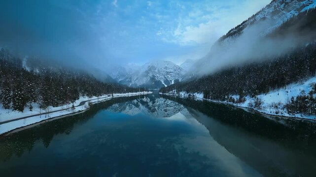 Snowy mountain lake in a peaceful winter landscape background