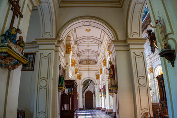 Side aisle with statues of saints and arches inside St. Mary's Church in Negombo, Sri Lanka