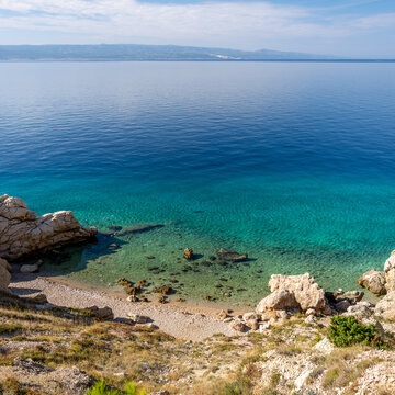 A view of a beach on the Makarska Riviera in Croatia. The beach in the town of Brela. An autumn view of the beach and the azure Adriatic Sea.