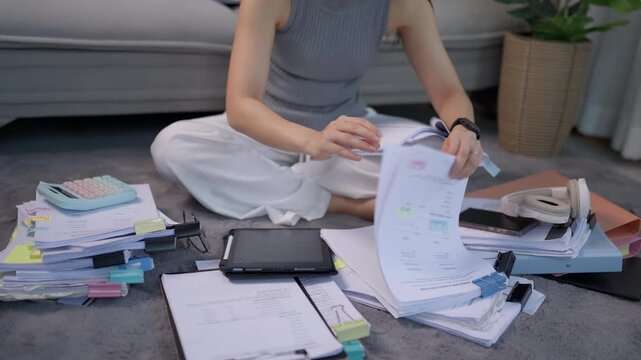 Woman Reviewing Financial Documents While Working from Home