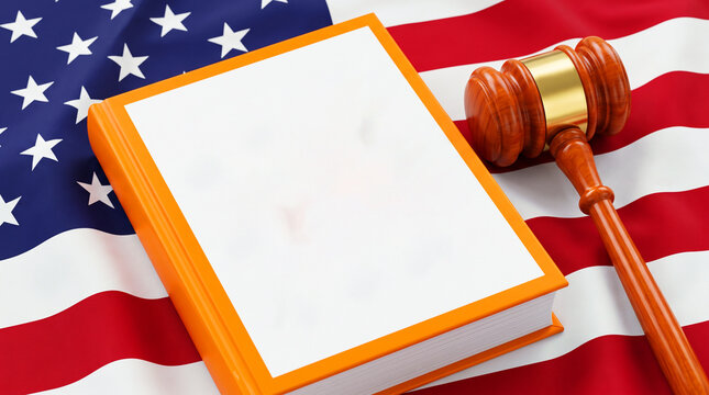 Wooden judge gavel and orange law book on american flag background