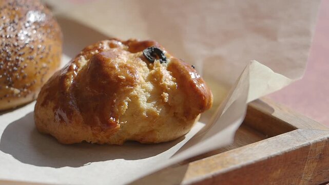 Freshly baked scone served on a wooden tray in a cafe setting