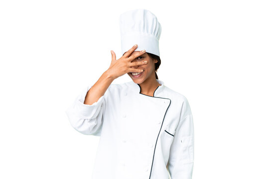 Young African American chef over isolated chroma key background covering eyes by hands and smiling