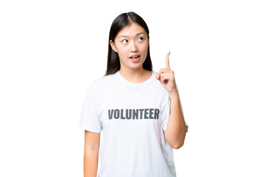 Young volunteer woman over isolated chroma key background thinking an idea pointing the finger up