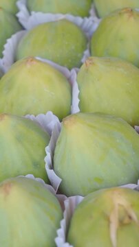 Ripe green figs presented in neat rows, showcasing fresh organic fruit