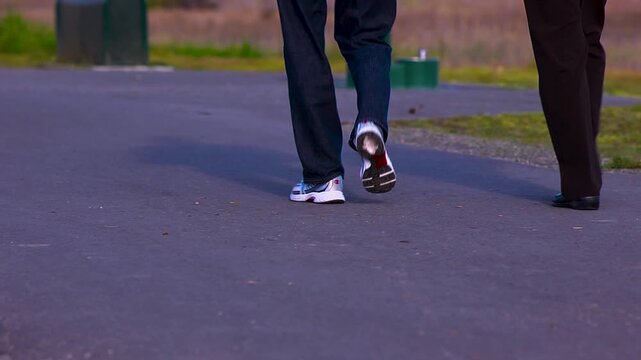 Close up of peoples feet walking in the park