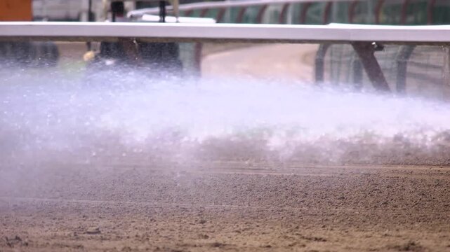 Close up of track water truck shooting out water to keep the dirt wet