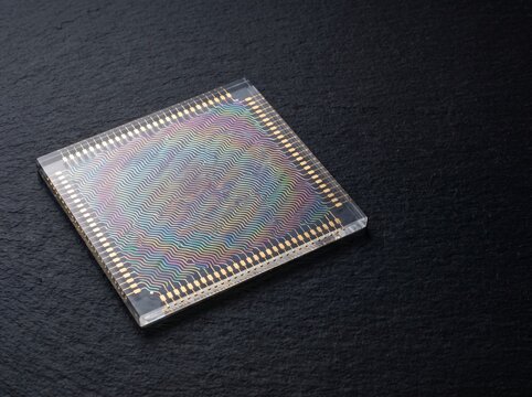 Macro studio photograph of electrodynamic dust shield panel displaying micro patterned transparent indium tin oxide ito electrodes on optical glass for lunar regolith dust mitigation system