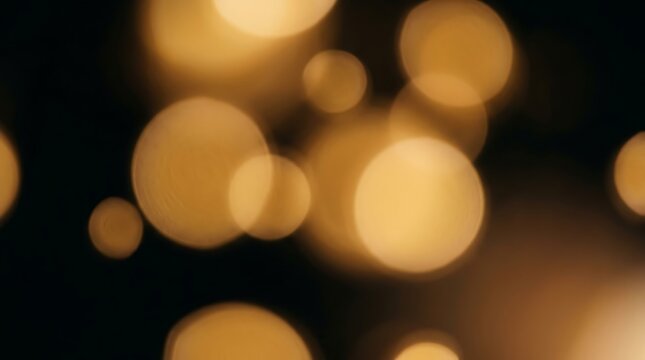Golden bokeh light circles on black background