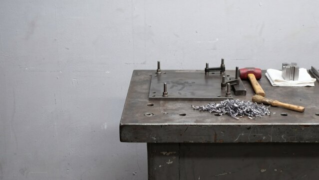 Fixture plate being set up on a milling bench with toe clamps only part tightened