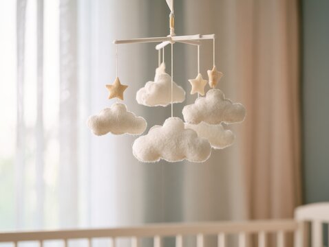 Soft Cloud and Star Mobile Hanging Above Baby Crib Near Window