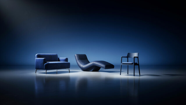 Three pieces of dark blue furniture including a sofa, lounge chair, and armchair in spotlight