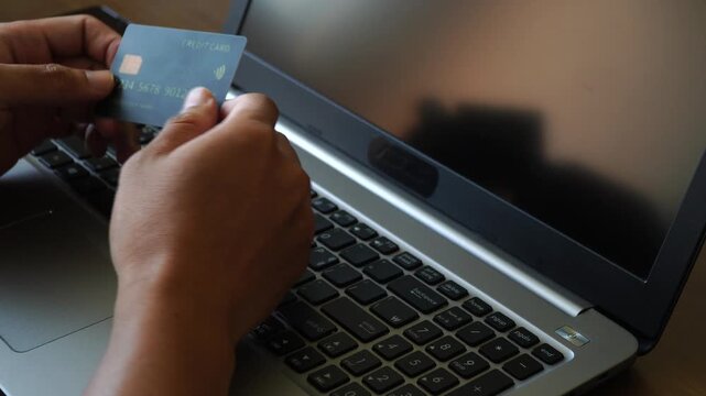 Person Paying Online with Credit Card on Laptop for E commerce Transaction