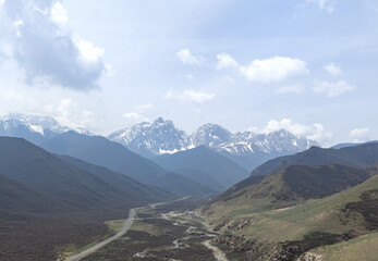 Snowy Mountain Range Above Winding River Valley © PhanThi