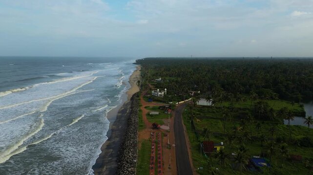    Aerial Drone View of Kappil Beach and Kappil Lake Separated by a Coastal Road in Varkala, Kerala, India