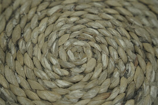 Close-up view of tightly woven natural jute rope texture with intricate spiral pattern