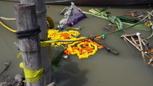 Polluted river bank with religious waste thrown