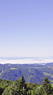 Panning from mountain over foggy valley