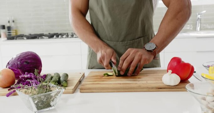 Lifestyle videos indoor of people doing activities at home, chopping vegetables on board, man prepar