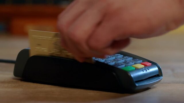 Close up man At Counter Buy electronic payment supermarket by credit card. Male hand pay for purchases in stores Contactless NFC pos Terminal card reader at cashless wallet. swipe. shop. Electronic