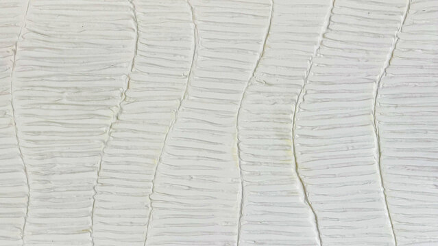 Abstract white plaster wall texture with handmade uneven lines and organic relief pattern, neutral textured background for interior design and creative projects.