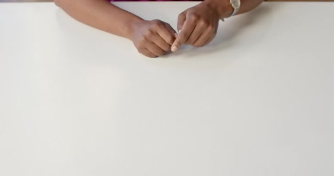Close-up of people talking to the camera, gesturing with hand, person explaining concept on white ta