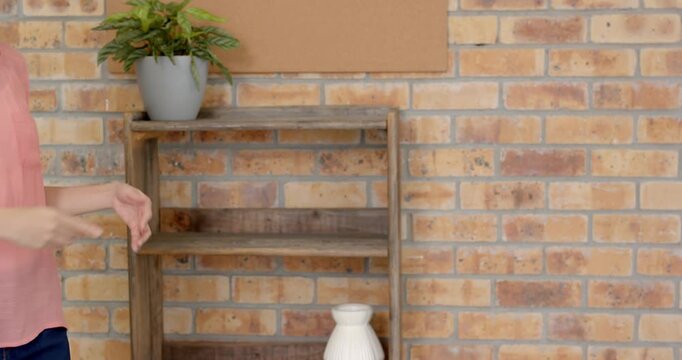 Close up of people talking to the camera, gesturing with hands, woman standing in front of brick wal