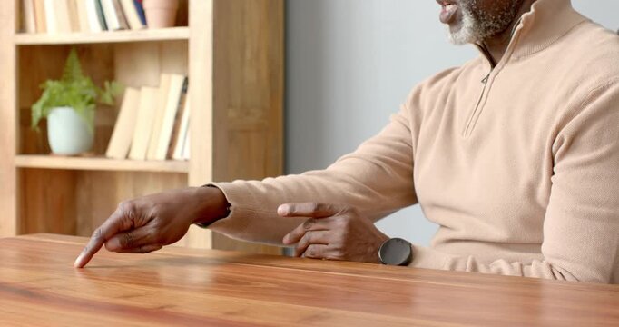 Close up of people talking to the camera, using sign language, man communicating at wooden table in