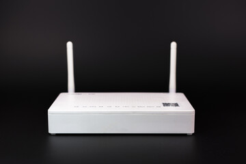 Fototapeta premium White wireless router with two antennas on dark background