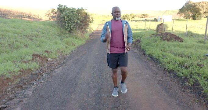 Lifestyle videos outdoor of people doing activities, jogging on rural road, man enjoying outdoor exe
