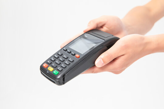 Hands Holding Portable Card Payment Terminal on Light Background