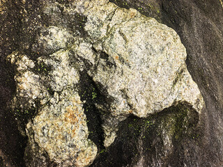 Weathered Rocks on Dark Volcanic Sand © TranThi