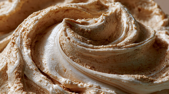 close up macro shot of creamy swirled peanut butter texture showing smooth waves and rich brown color representing delicious natural spread