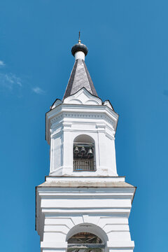 White Trinity Cathedral bell tower in Tver Russia, historic Orthodox church against blue sky