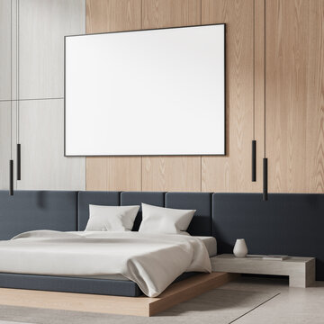 Modern bedroom interior with empty framed wall poster mockup, warm wood paneling, pendant lighting, and contemporary design. 3D Rendering
