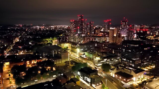 Manchester UK: 16th August 2026: A drone view of the Manchester skyline near Central shows buildings illuminated by city lights at night