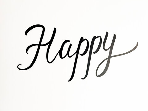 Sign Happy on a white background. Close-up.