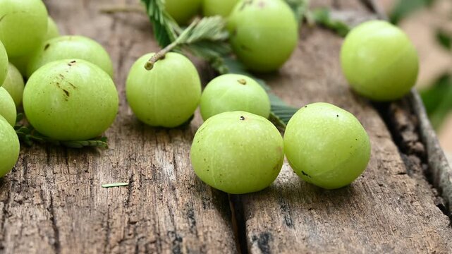Fresh Amla (Indian gooseberry) fruits on wooden table background