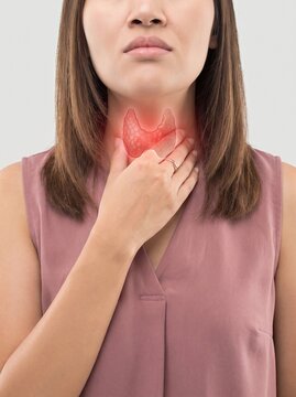 Woman touching her throat area experiencing thyroid gland discomfort