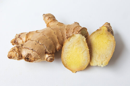 Fresh ginger root with ginger slices isolated on a white background. Sliced ginger. Close-up ginger root.