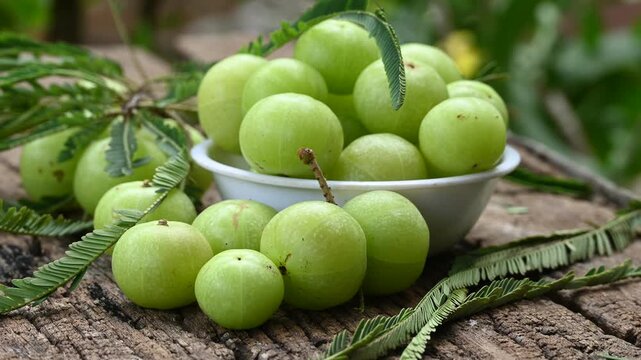 Fresh Amla (Indian gooseberry) fruits on wooden table background