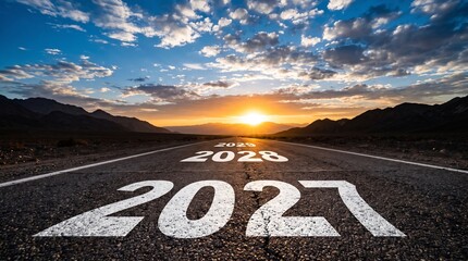 Obraz premium Painted white year markers on gray asphalt road showing future progress towards bright sunny horizon line