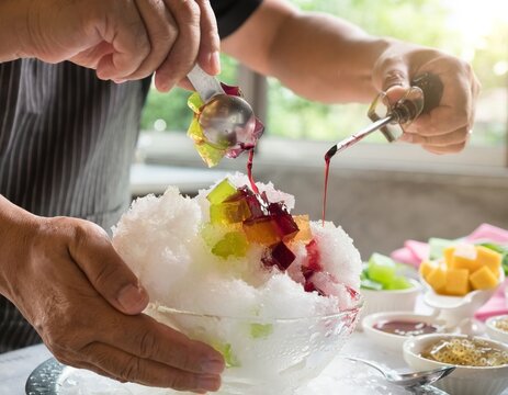 Delicious Shaved Ice Dessert Being Prepared with Toppings.