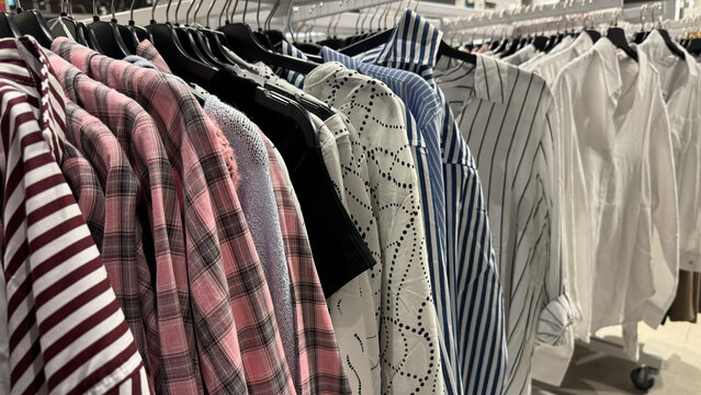 Assorted Fashion Shirts And Blouses Displayed On Clothing Rack