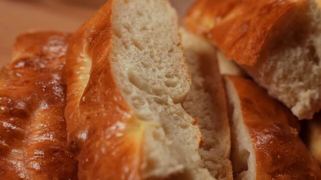Close up bread loaf slices with golden crust, soft pale crumb and crisp crackle texture in warm cozy bakery scene for fresh home baked flavor