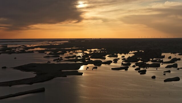 Dramatic Sunset Over Water Yardang Rocks